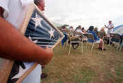 A casket flag is presented by the family of a former crew member...
